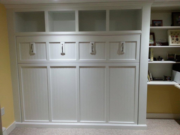 Custom built-in pull down queen size Murphy bed for a basement office. Unit was designed to fit in a tight space between an existing bookcase and corner. The unit was built as several components and assembled and installed on site so that we could get it down the tight staircases.